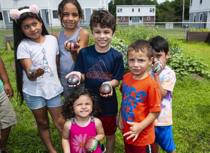 Children at Robinson Gardens show painted rocks to identify plants