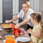 woman cooking iwth child