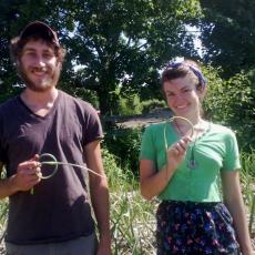 GardenShare students, Jacob Harness and Chloe Rombach with garlic scapes