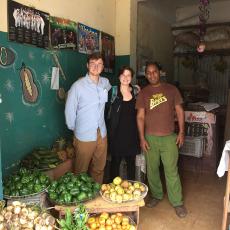 UMass Amherst students and Cuban worker in open air market