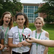 4-H young women perpare to fly drone