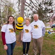 Shaun Fitzgerald, UMass alum and beekeeper with honor students and bee pinata