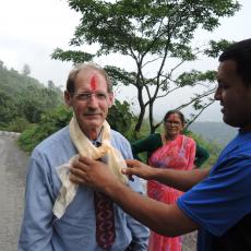 Traditional farewell: red mark on forehead and scarf. The woman in red  sari is an extension agent, a plant and soil scientist