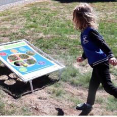 Child playing MyPlate bean bag toss