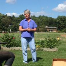 UMass Extension Educator, Sonia Schloeman teaches attendees at Powisett Farm