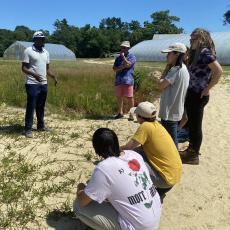 Extension Ass. Prof. Giverson Mupambi teaches REEU students about cranberry physiology at the UMass Cranberry Station