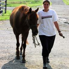 Student walking horse at the Hadley Farm