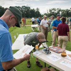 Visitors to the Joseph Troll Turf Research Center participate in an interactive display on techniques to improve turf establishment