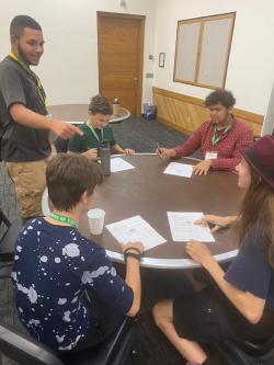 4-H Youth working and talking to program staff. 