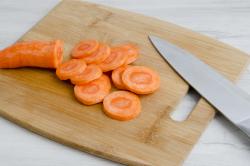 raw carrots chopped on cutting board