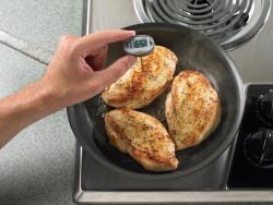 chicken cooking with thermometer