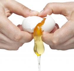 hands cracking an egg