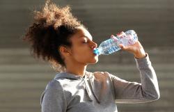 woman drinking bottle of water