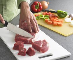 cutting meat on cutting board