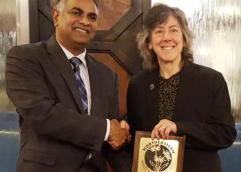 Dr. Rakesh Chandran, NEWSS Past-President presents award to Dr. Hilary Sandler