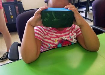 girl using virtual reality goggles