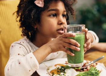 young girl with green drink