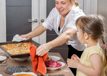 woman cooking iwth child
