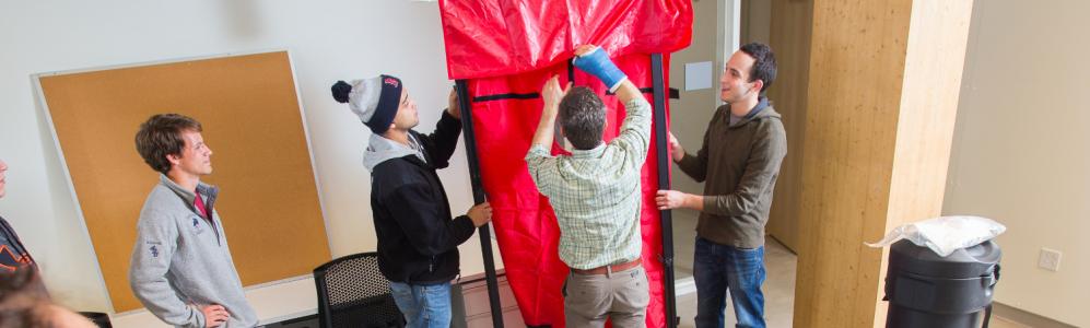 Students learn correct techniques for blower door tests