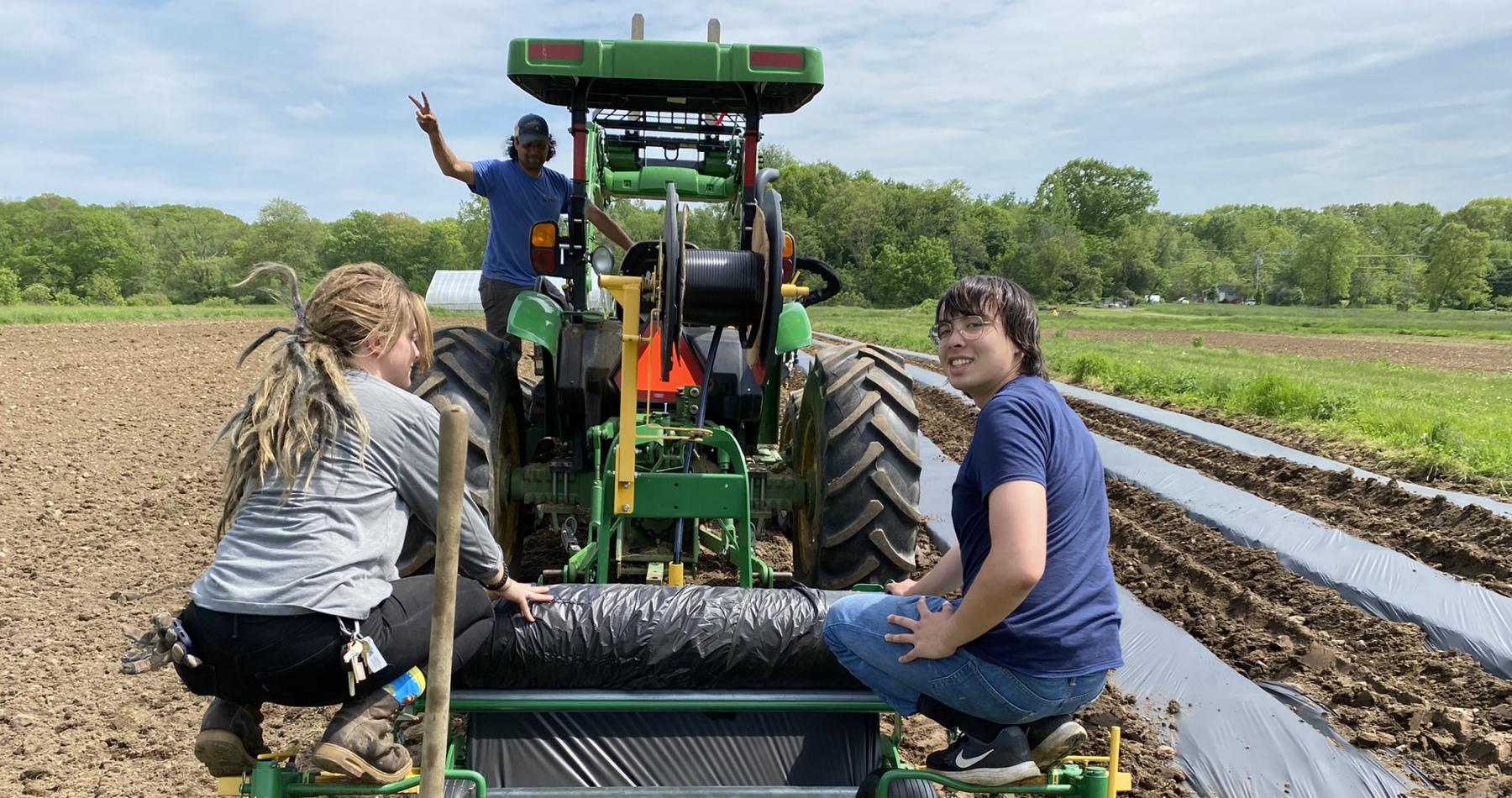 Matthew Bley rides a tractor while learning about healthy soils in the REEU program. 