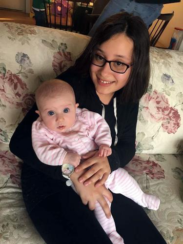 Ana Lois, 4-H member from Southwick babysits infant