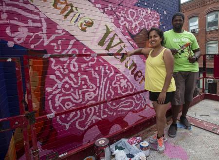Artists Priya Nadkarni and Ahdrae Green paint mural on Taylor Street, Springfield