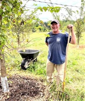 Scott Hathaway, Westfield tree warden and SSA graduate, helps maintain growing elms on Dakin Frield at UMass Amherst