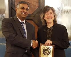 Dr. Rakesh Chandran, NEWSS Past-President presents award to Dr. Hilary Sandler