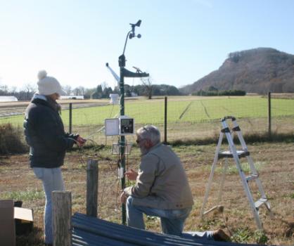 Elizabeth Garofalo and Jon Clements install watehr station at UMass Agronomy Farm in  South Deerfield