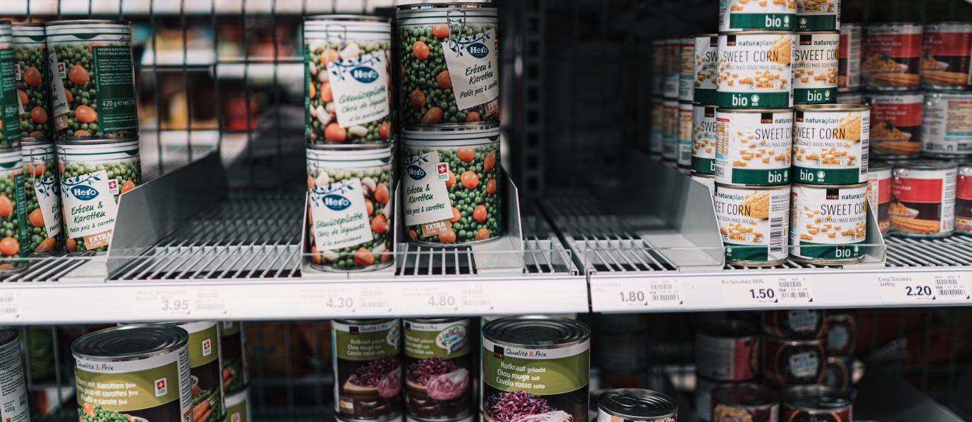 canned food on shelf by claudio schwarz on unsplash