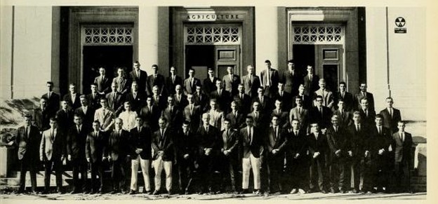 The 64 undergraduate members of the Turf Club from the class of 1964 standing on the steps of Stockbridge Hall.
